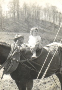 Amon Cantrell and Woodena (1yr old) sitting on a mule